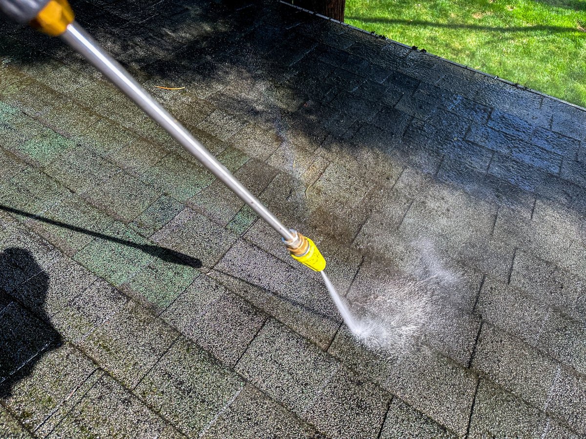 low pressure roof cleaning washing shingles on a Spokane home