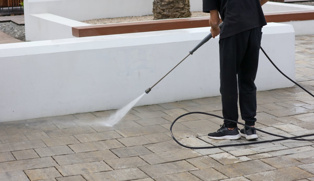 House washing a Spokane home's exterior siding with a low-pressure spray
